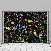 Black and colorful paint splatter backdrop with white wooden floor background.